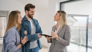 Female real estate agent talking to a couple.